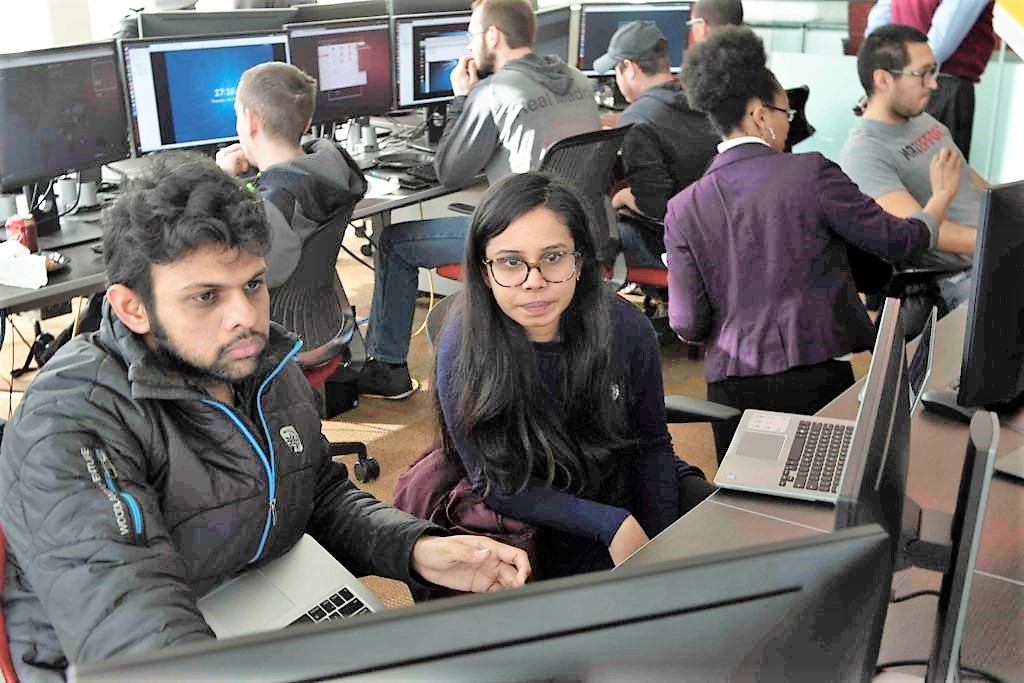 image of students looking at a computer