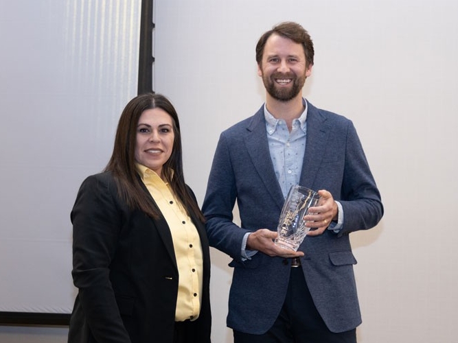 Kevin Jordan holding award with Christina Roybal